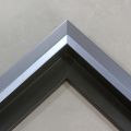 Unique geometric 1 " floater. The face of this molding features an off center peak which gives it a unique contrast in the right lighting.  This frame comes in Metallic Blue Pewter with a dull satin finish.